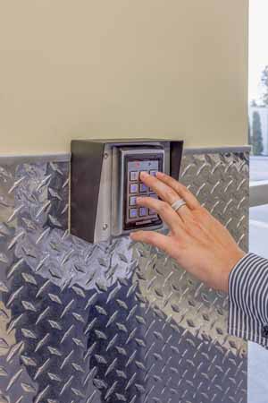 Person using keypad for remote entry to a self storage facility.