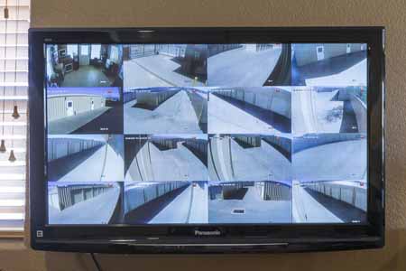 Security camera footage on display in the lobby of a self storage facility.