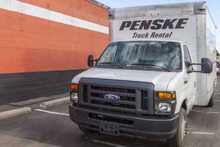 Moving truck parked outside of a self storage facility.