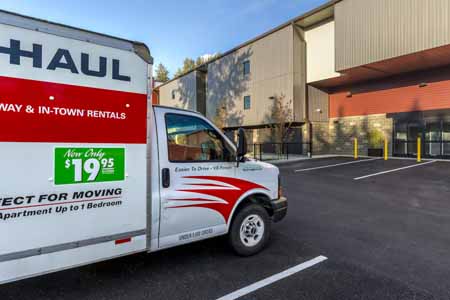 Uhaul parked outside of a self storage facility.